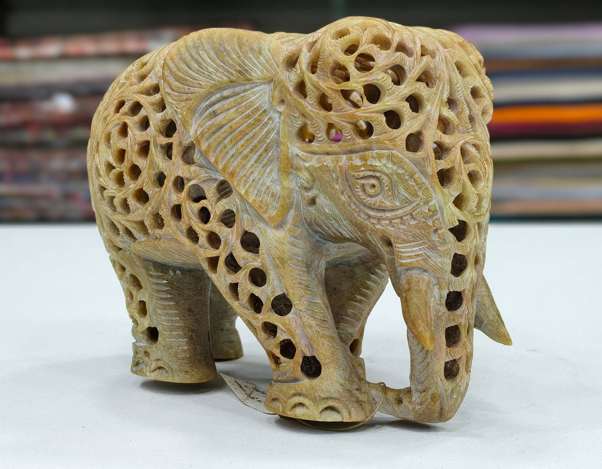 hand-carved soapstone elephant sculpture featuring intricate "jali" lattice openwork