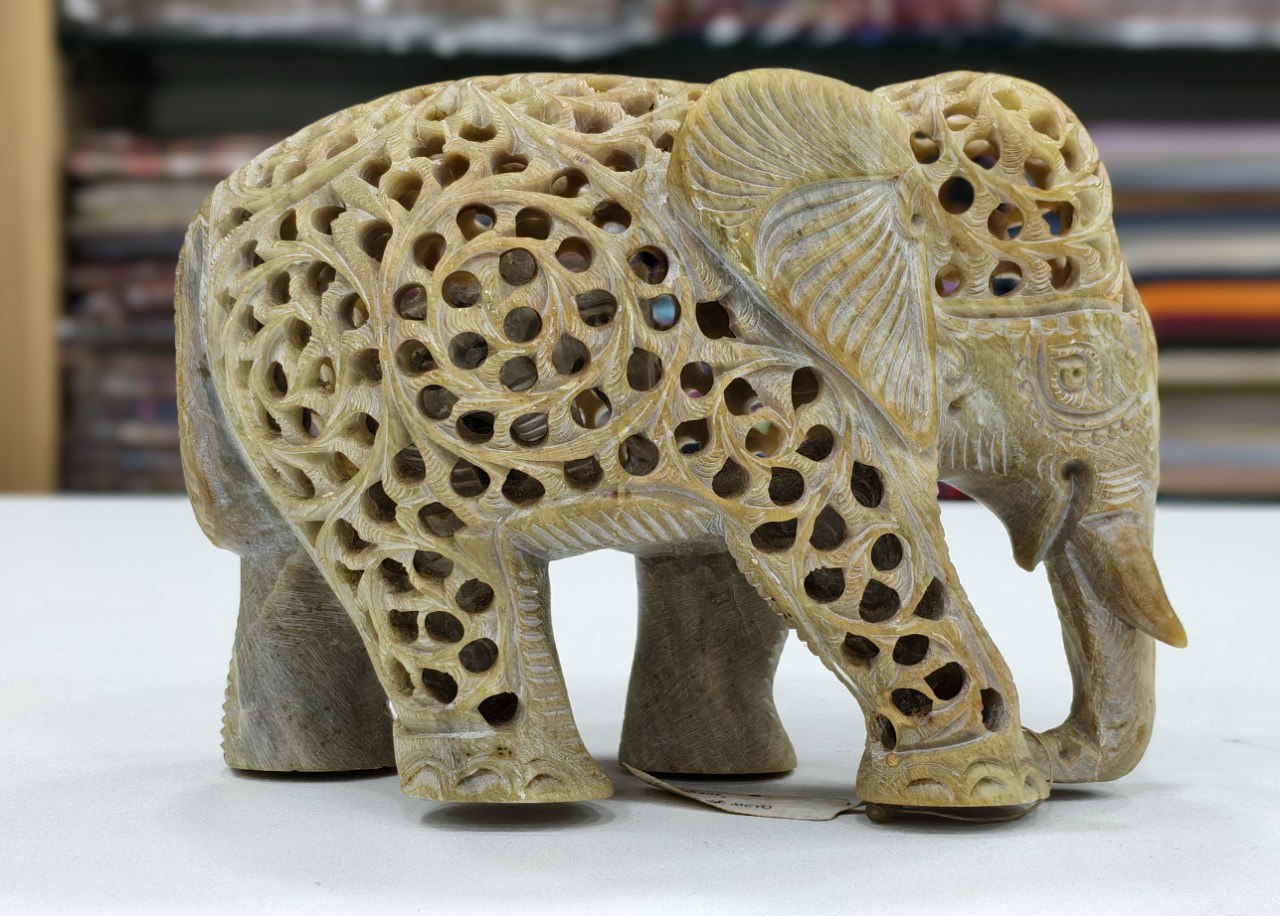 hand-carved soapstone elephant sculpture featuring intricate "jali" lattice openwork