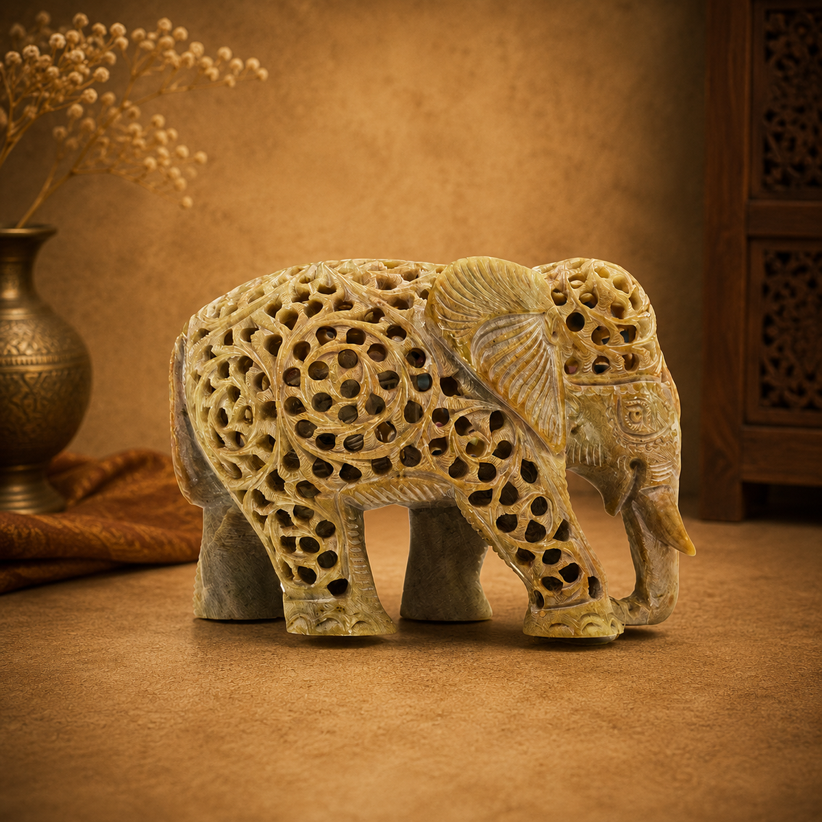 hand-carved soapstone elephant sculpture featuring intricate "jali" lattice openwork
