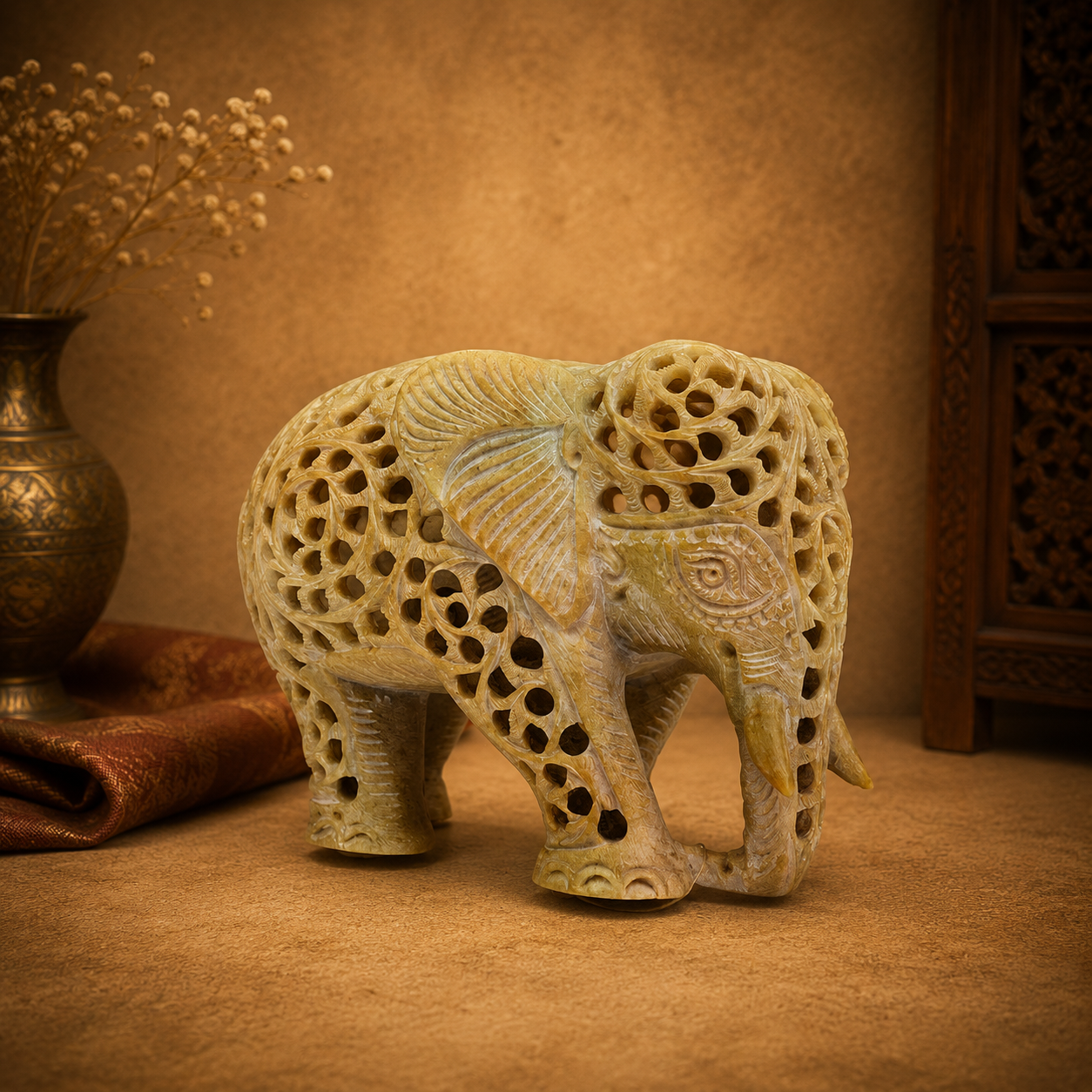 hand-carved soapstone elephant sculpture featuring intricate "jali" lattice openwork