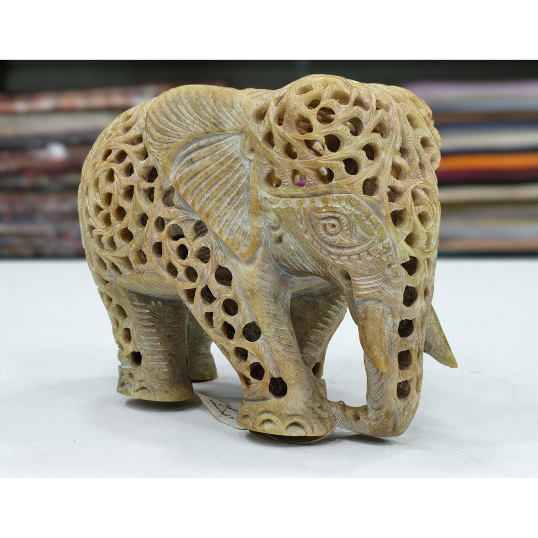 hand-carved soapstone elephant sculpture featuring intricate "jali" lattice openwork